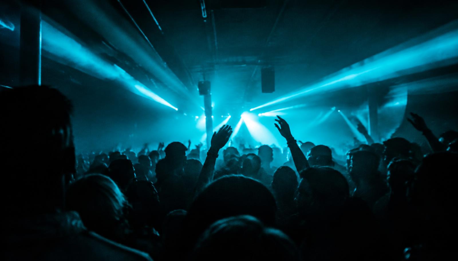 Club crowd under cyan lights